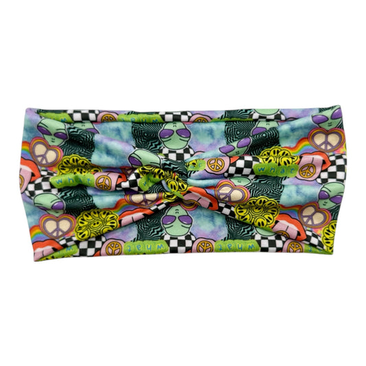 Colorful fabric with peace signs, checkered patterns, and other designs on a white background