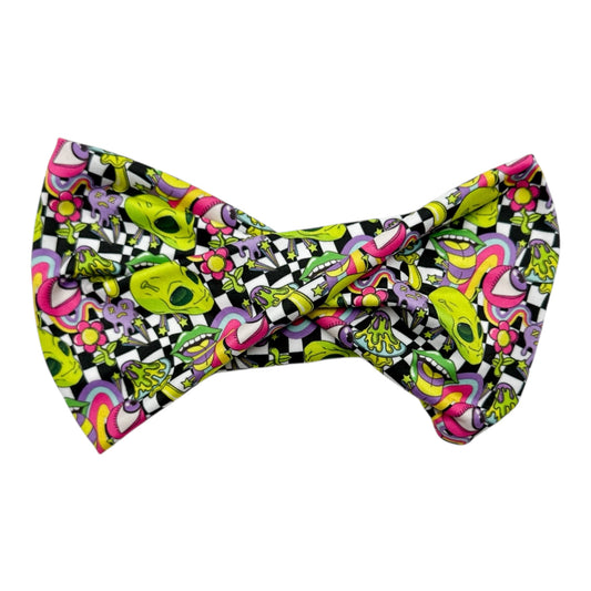 Colorful bow tie with a pattern of skulls and checkered design on a white background