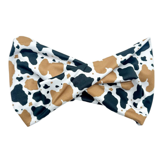 Cow print headband on a white background