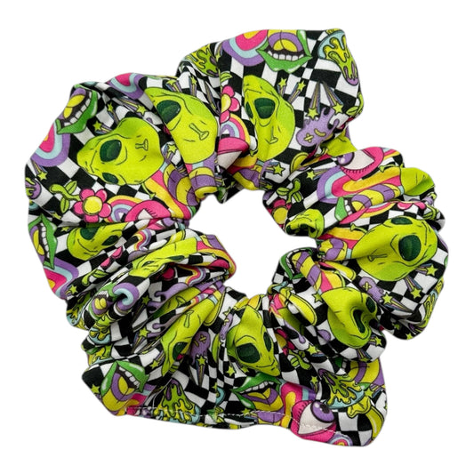 Colorful alien patterned scrunchie on a white background