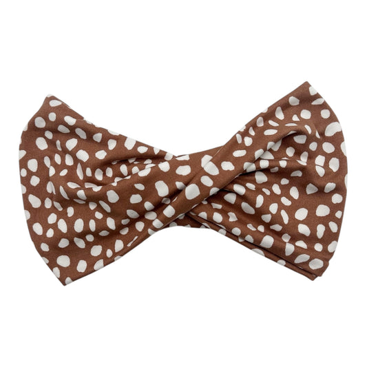 Brown bow tie with white polka dots on a white background