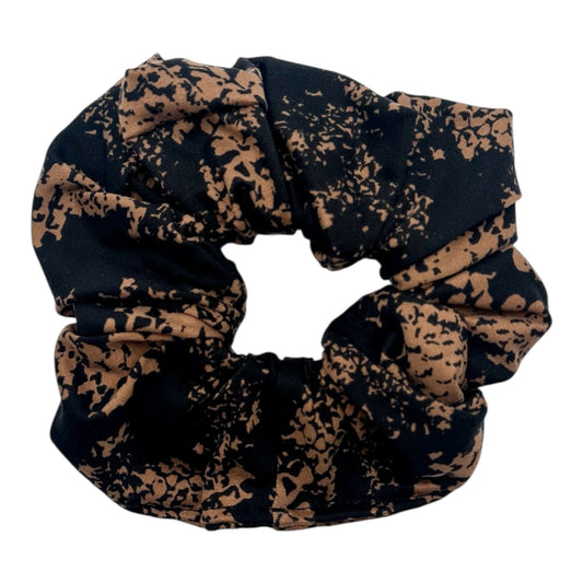 Black and brown patterned scrunchie on a white background