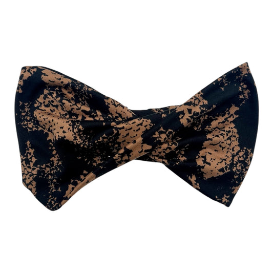 Black and brown patterned bow tie on a white background