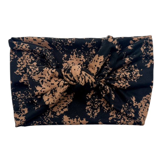 Navy blue headband with gold floral pattern on a white background